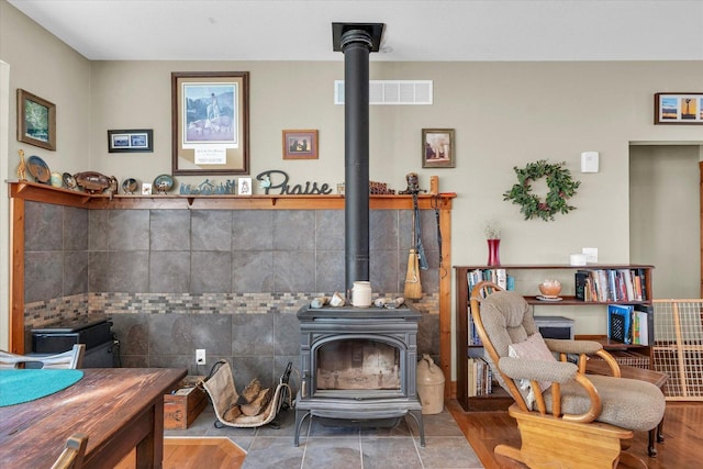 room details featuring a wood stove and visible vents