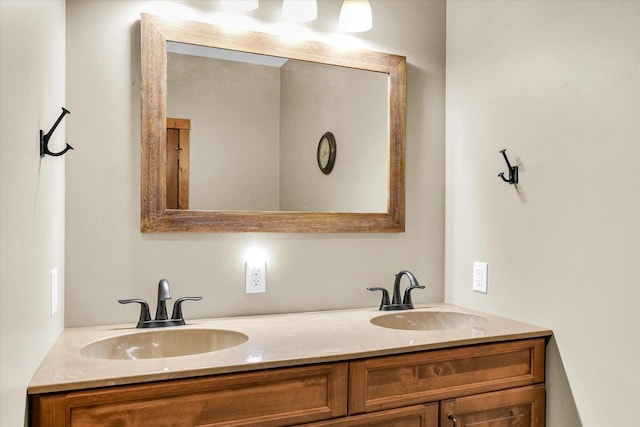 bathroom featuring a sink and double vanity