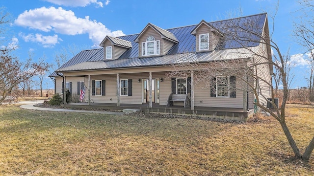 view of front of house featuring covered porch, metal roof, and a front yard