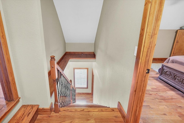 stairway with wood finished floors