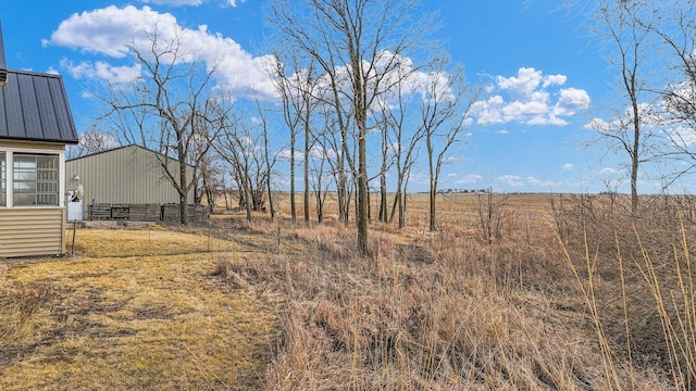 view of yard with a rural view