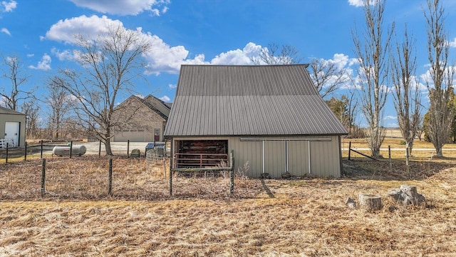 view of barn with fence