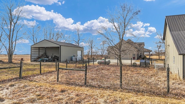 view of yard featuring an outbuilding and fence