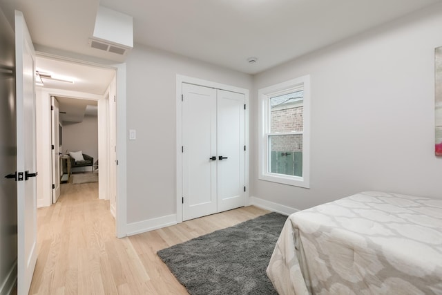 bedroom featuring light hardwood / wood-style floors and a closet