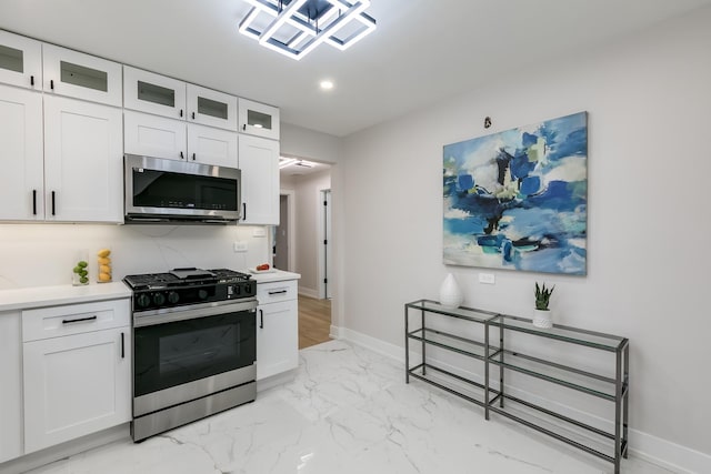 kitchen with white cabinetry and gas range oven