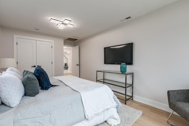 bedroom featuring light hardwood / wood-style floors and a closet