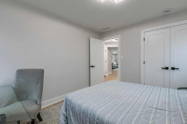 bedroom with a closet and light wood-type flooring