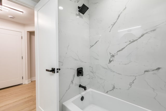 bathroom featuring hardwood / wood-style flooring and tiled shower / bath combo