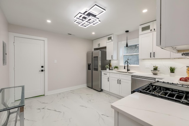 kitchen with pendant lighting, stainless steel refrigerator, and white cabinets