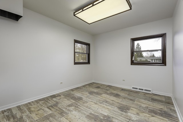 unfurnished room with hardwood / wood-style flooring