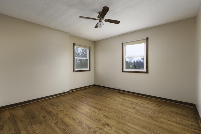 spare room with wood-type flooring, ceiling fan, and a textured ceiling