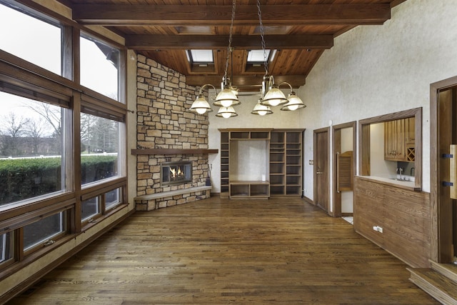 unfurnished living room featuring plenty of natural light, wood ceiling, and dark hardwood / wood-style flooring