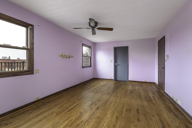 unfurnished room featuring ceiling fan and dark hardwood / wood-style flooring