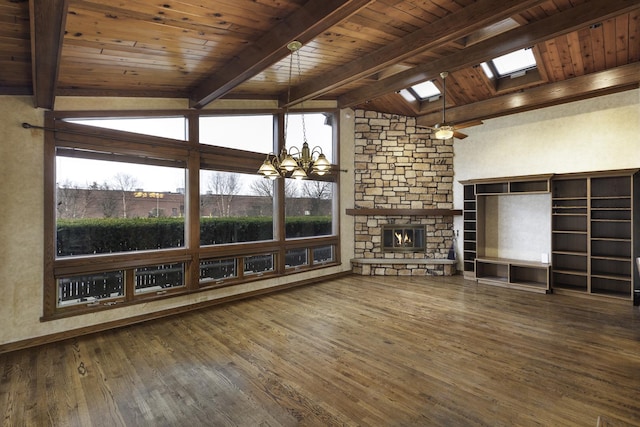 unfurnished living room with a stone fireplace, wood-type flooring, lofted ceiling with skylight, and plenty of natural light