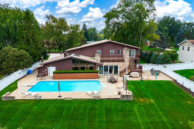 back of property featuring a fenced in pool, a yard, and a patio area