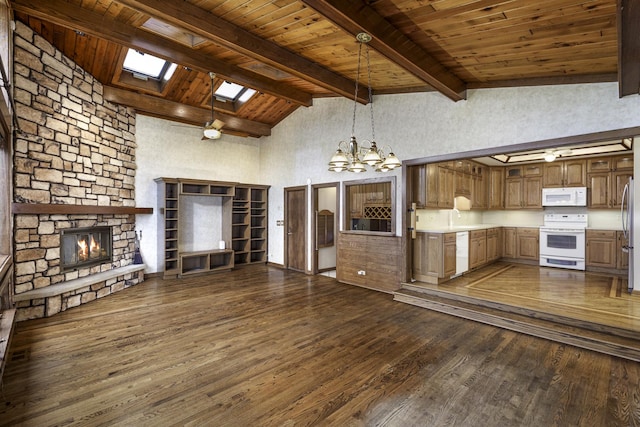 unfurnished living room featuring wood ceiling, dark wood-type flooring, beam ceiling, a skylight, and a fireplace