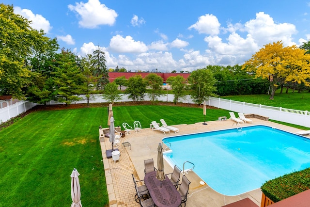 view of pool with a patio area, a diving board, and a lawn