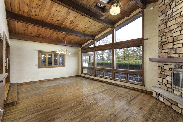 unfurnished living room with dark hardwood / wood-style floors, a fireplace, and lofted ceiling with beams