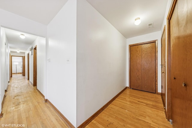 corridor with light wood-type flooring