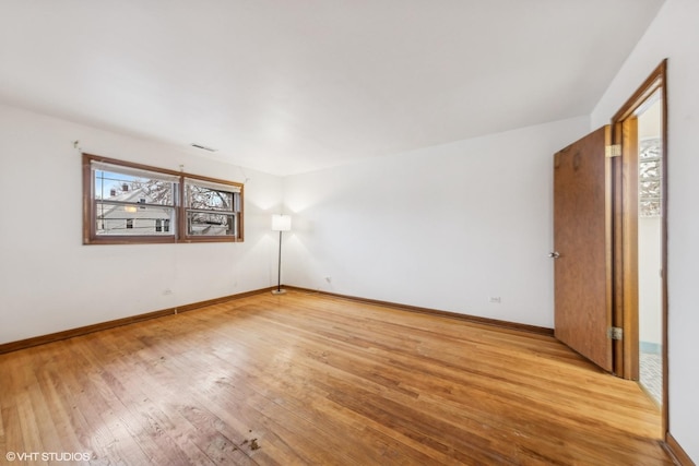 spare room with light hardwood / wood-style flooring