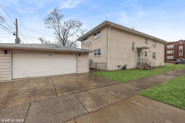 view of side of home featuring a garage, an outdoor structure, and a lawn