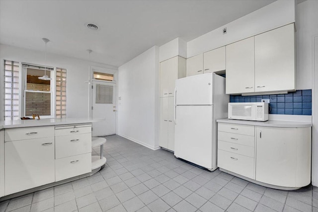 kitchen with light tile patterned floors, white appliances, decorative backsplash, and white cabinets