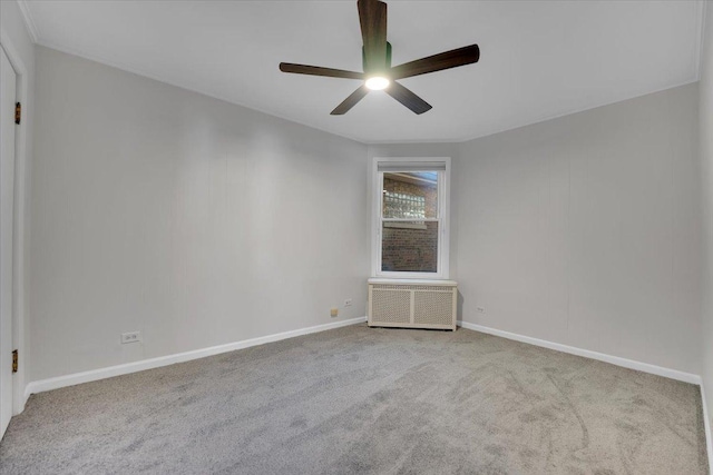 empty room with radiator, light colored carpet, and ceiling fan