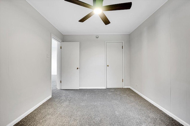 carpeted empty room featuring ceiling fan