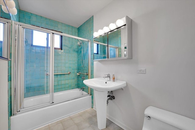 bathroom with shower / bath combination with glass door and toilet