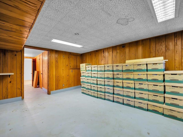 basement featuring wood walls