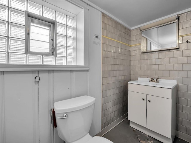 bathroom with vanity, concrete floors, and toilet