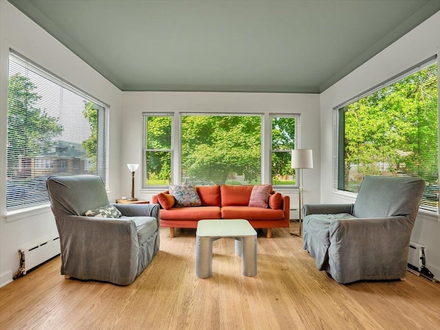 sunroom featuring a baseboard radiator and plenty of natural light