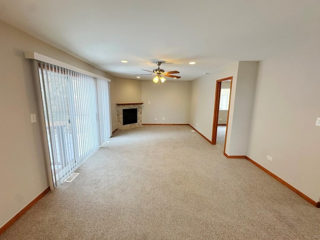 unfurnished living room featuring a wealth of natural light, light colored carpet, and ceiling fan