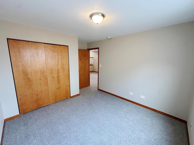 unfurnished bedroom with carpet flooring and a closet