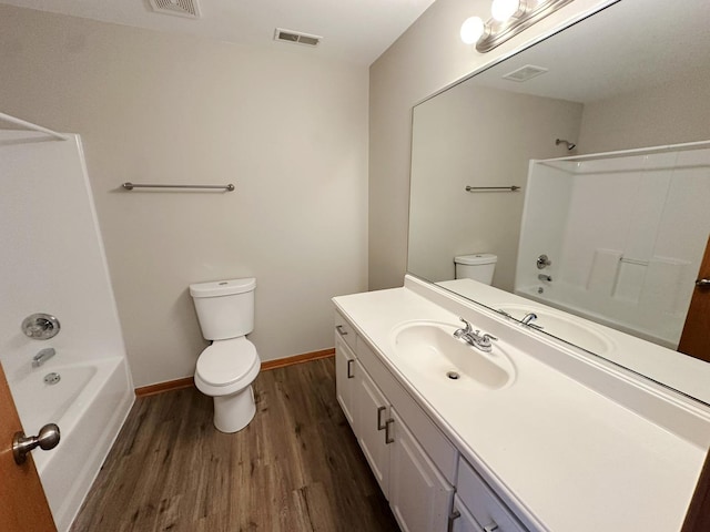 full bathroom with vanity, hardwood / wood-style flooring, shower / washtub combination, and toilet