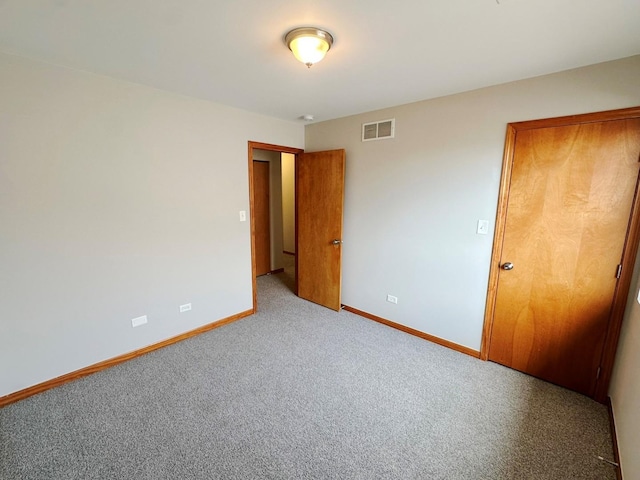 unfurnished bedroom with light colored carpet