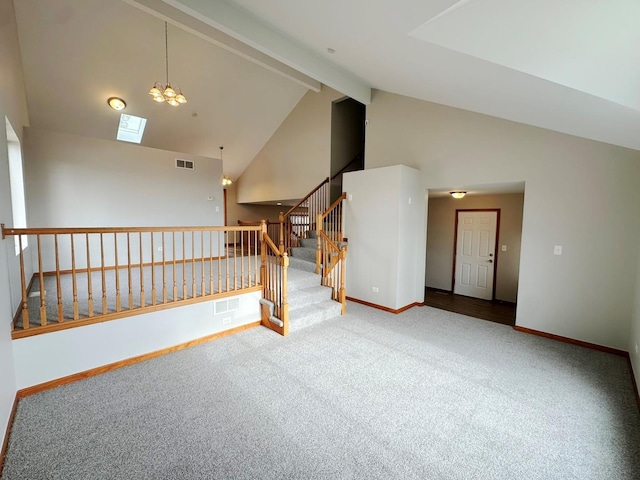 spare room with a notable chandelier, high vaulted ceiling, beamed ceiling, and carpet