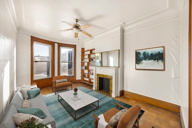 living room featuring crown molding and ceiling fan