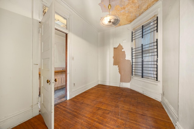 unfurnished room with ornamental molding and dark hardwood / wood-style flooring