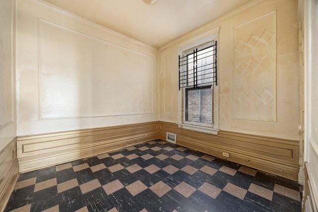 unfurnished room featuring crown molding