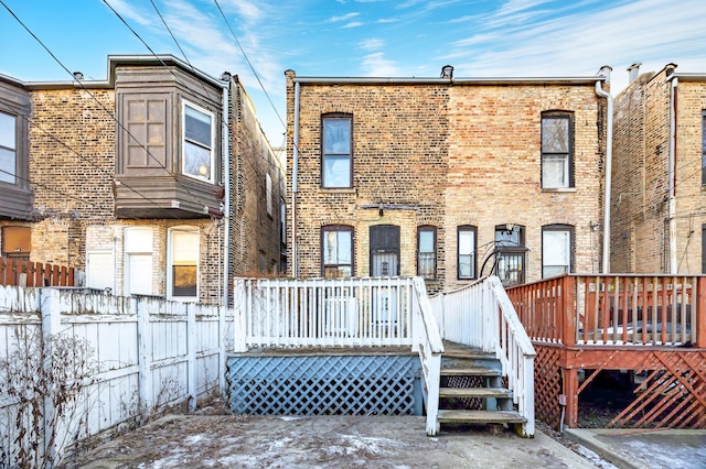 back of property featuring a wooden deck