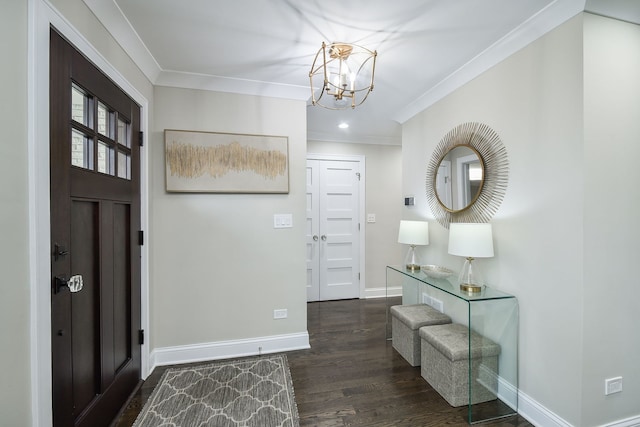 entryway with crown molding, a chandelier, and dark hardwood / wood-style flooring