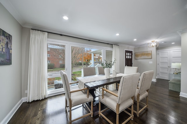 dining area with a notable chandelier, dark wood-type flooring, and ornamental molding