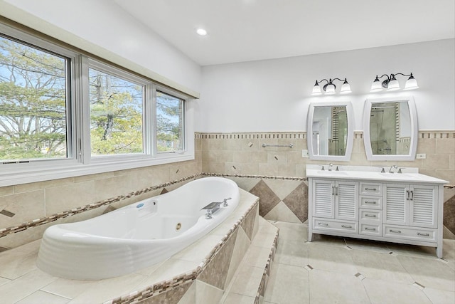 bathroom featuring vanity, tiled bath, tile patterned flooring, and tile walls