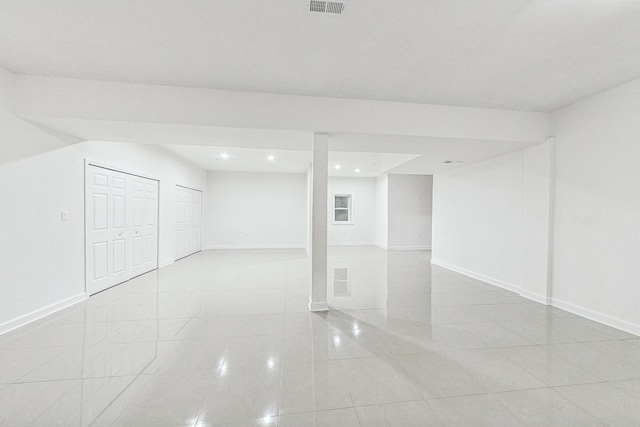 basement featuring light tile patterned floors