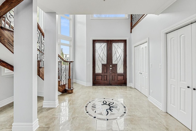 foyer featuring french doors and a high ceiling