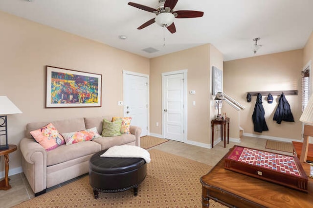 living room with ceiling fan and light tile patterned flooring