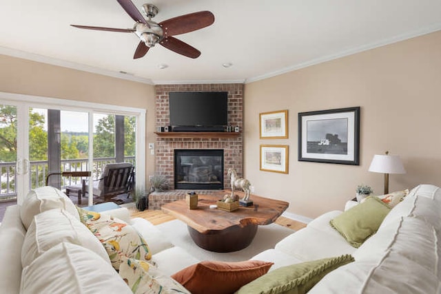 living room featuring hardwood / wood-style flooring, crown molding, a brick fireplace, and ceiling fan