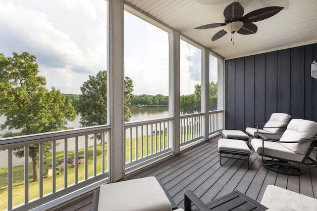 sunroom featuring a water view and ceiling fan