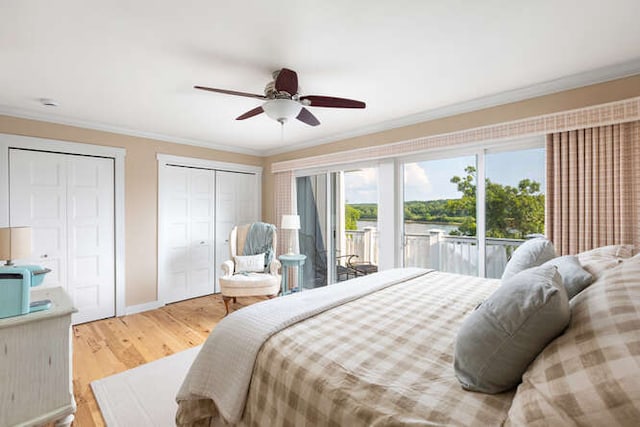 bedroom with ornamental molding, access to outside, ceiling fan, light hardwood / wood-style floors, and multiple closets